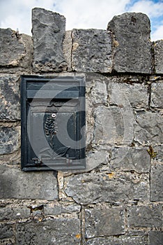 post box, embedded in a stone wall