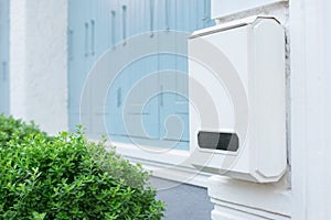 Post box on white wall with green nature, White Mailbox