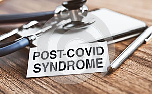 Post-covid syndrome symbol. White card with inscription. Medical and post-covid syndrome concept. Copy space