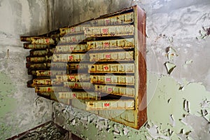 Post mail boxes in abandoned building in ghost town Pripyat Chornobyl Zone photo