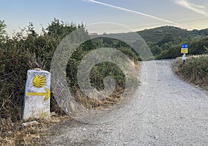 Post mark with the yellow shell and arrow that guides the pilgrims along the Camino de Santiago, Spain. photo