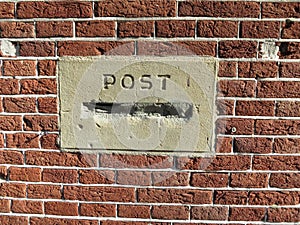 Post mortem, post box or mailbox stopped up with cement in a red brick wall