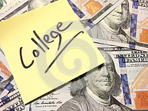 Post it note with hardwritten college on american cash money photo