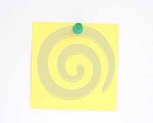 Yellow note pinned to white paper wall photo