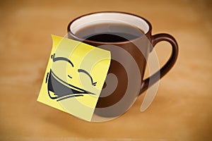 Post-it note with smiley face sticked on cup