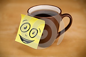 Post-it note with smiley face sticked on cup