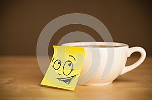 Post-it note with smiley face sticked on cup