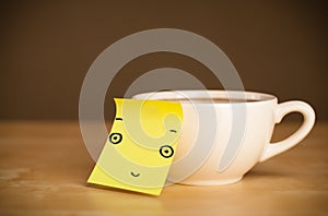 Post-it note with smiley face sticked on a cup