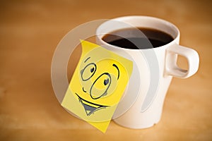 Post-it note with smiley face sticked on cup