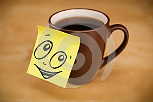 Post-it note with smiley face sticked on cup
