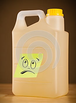 Post-it note with smiley face sticked on gallon