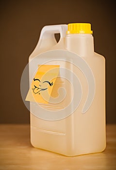 Post-it note with smiley face sticked on gallon