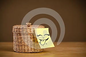 Post-it note with smiley face sticked on jewelry box