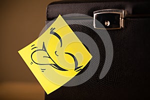 Post-it note with smiley face sticked on jewelry box