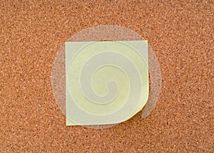 Post it notes on cork board .