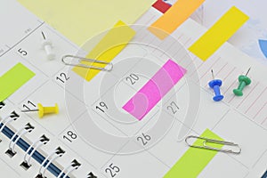 Post It notes with pin and clip on business diary page