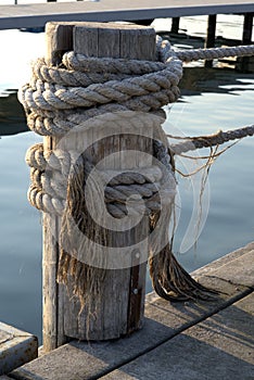 Post and rope on marina dock