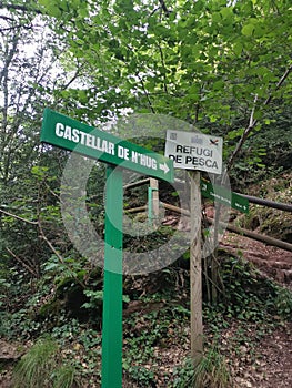Post sign directions to the El Llobregat river spring and Castellar de n'Hug, Catalonia, Spain