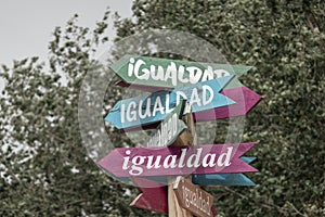 Post with wooden signs with the written word in Spanish `igualdad` equality. photo