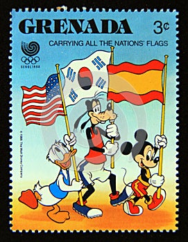 Postage stamp Grenada 1988. Donald Duck, Goofy and Mickey Mouse carrying flags