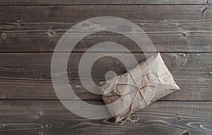 Postal package wrapped in craft paper on white background