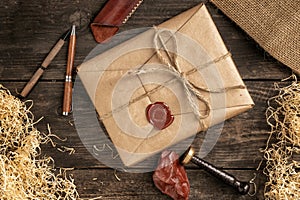 a postal parcel wrapped in wrapping paper and tied with ropes with a sealing wax seal lies