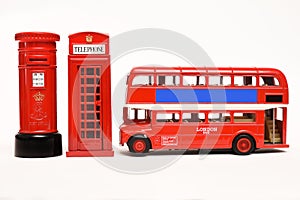 Postbox and red telephone box with red bus