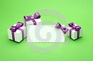 Postcard and gifts on green background