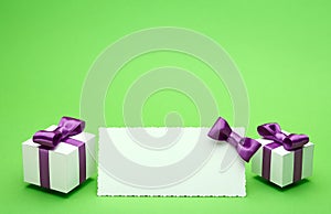 Postcard and gifts on green background
