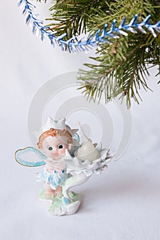 Postcard greetings happy New year, magic elf, fir branch, candle holder, Christmas gifts under the tree, the angel candle, on a wh