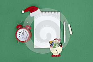 Postcard Happy New Year Flat lay composition with scroll and Christmas decor on green color background.