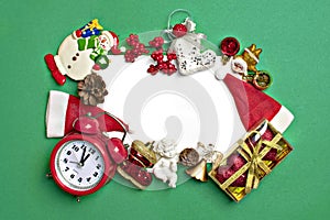 Postcard Happy New Year Flat lay composition with scroll and Christmas decor on green color background.
