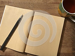 Postcard or note paper with notebook on wooden brown background