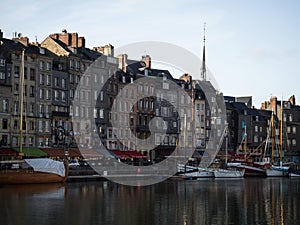 Postcard panorama of old historic building facades in port harbor of fishing village town Honfleur Normandy France
