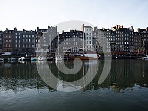 Postcard panorama of old historic building facades in port harbor of fishing village town Honfleur Normandy France