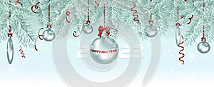 Postcard with silver Christmas tree toys on pine branches. A festive, falling red confetti. 2023 Happy New Year. Background with