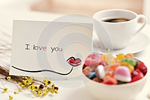 Postcard with the text I love you on a table