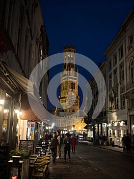Postcard view of illuminated Belfry of Bruges Belfort van Brugge medieval historical bell clock tower at night Belgium