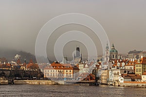 Postcard view of Lesser Town in mist from Charles Bridge,Czech republic.Famous tourist destination.Prague panorama.Foggy photo