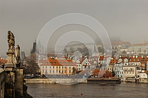Postcard view of Prague Castle in mist from Charles Bridge,Czech republic.Famous tourist destination.Prague panorama.Foggy morning photo