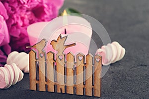 Postcard with wooden gate and birds, peony flowers, candle