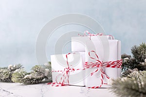 Postcard with  wrapped boxes with presents  and branches of fir tree