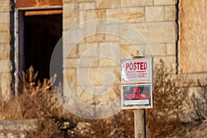 Posted for no trespassing on an old worn out house