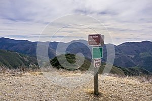 Posted signs showing distances and directions and other notices in Montana de Oro State Park placed on Oats Peak, one of the photo