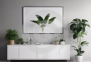 Poster above white cabinet with plant next to grey sofa in simple living room interior.