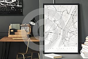 Poster and book on grey cabinet in workspace interior with gold