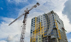 Poster construction building crane urban landmark apartment architecture shape exterior foreshortening from below on cloudy sky