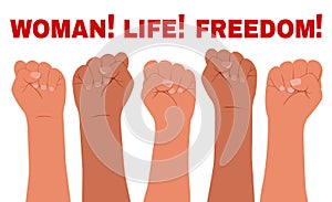 Banner with female hands clenched into a fist and the slogan - Woman, life, freedom.