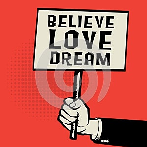 Poster in hand, business concept with text Believe Love Dream