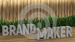 Poster lettering Brandmaker. Large letters on a wooden table. Modern decorative grass, backlit wall of wooden battens. Great loft